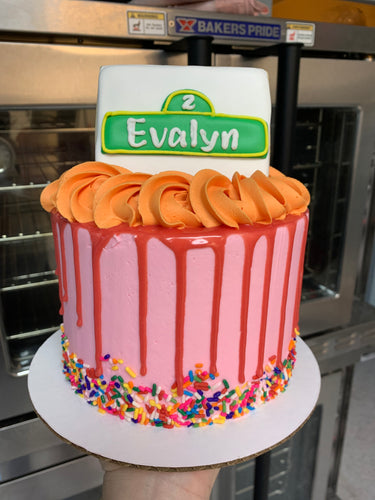 Pink cake with Street Sign Cookie Topper